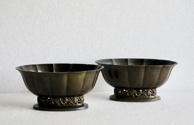 Just Andersen A pair of Just Andersen patinated disco metal planters