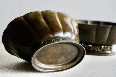 Just Andersen A pair of Just Andersen patinated disco metal planters