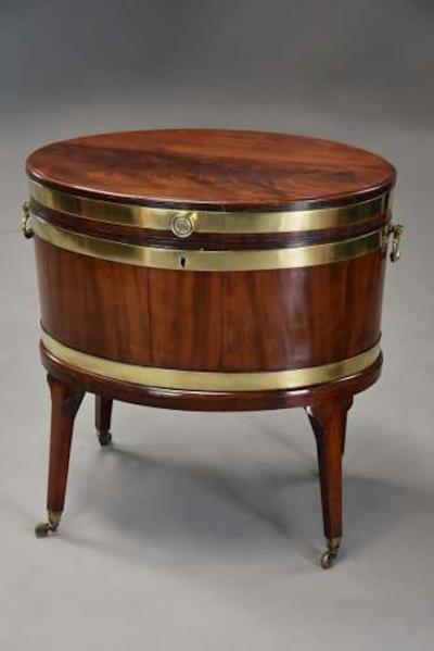 Large 18thc mahogany brass bound oval cellarette of fine patina