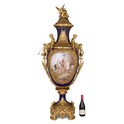 Large antique porcelain and ormolu vase painted with a genre scene