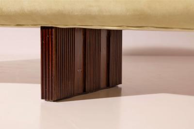 Large curved sofa with carved wooden supports Italy 1950s