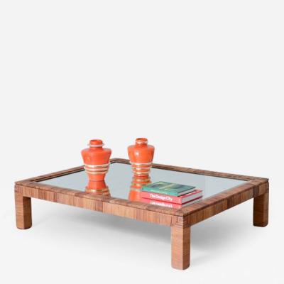 Large living room table covered in straw with mirrored glass top 