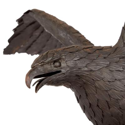 Large patinated steel and rock model of an eagle