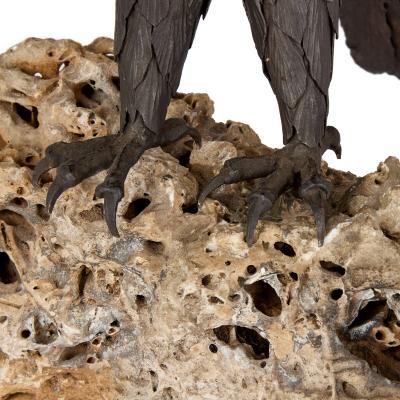 Large patinated steel and rock model of an eagle