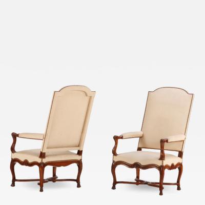 Large scale French walnut open arm chairs with hooved feet C 1900 