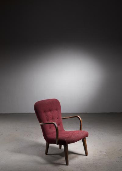 Lounge chair with curved armrests and red upholstery Denmark 1940s