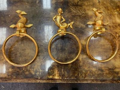MID CENTURY TRIO OF GOLD PLATED BRASS DOLPHINS AND MERMAID TOWEL RINGS