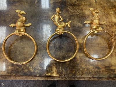 MID CENTURY TRIO OF GOLD PLATED BRASS DOLPHINS AND MERMAID TOWEL RINGS