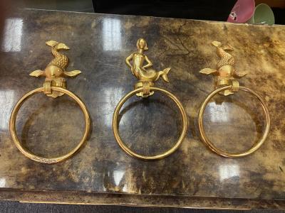 MID CENTURY TRIO OF GOLD PLATED BRASS DOLPHINS AND MERMAID TOWEL RINGS