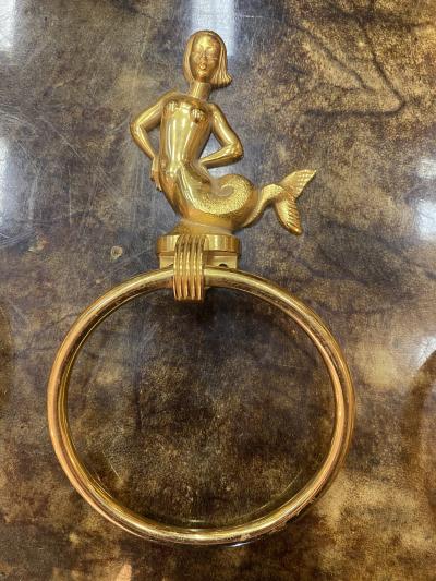 MID CENTURY TRIO OF GOLD PLATED BRASS DOLPHINS AND MERMAID TOWEL RINGS