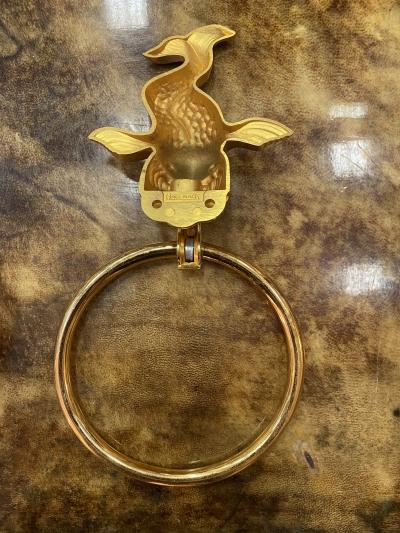 MID CENTURY TRIO OF GOLD PLATED BRASS DOLPHINS AND MERMAID TOWEL RINGS