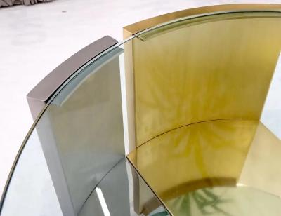 MODERNIST BRASS AND CHROME OVAL COFFEE TABLE IN THE MANNER OF MARIA PERGAY