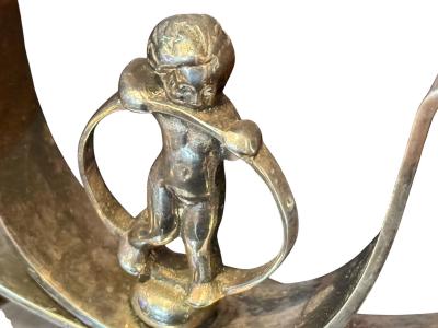MODERNIST PAIR OF ART DECO SILVERED CANDELABRA WITH STYLIZED CHERUB IN RING