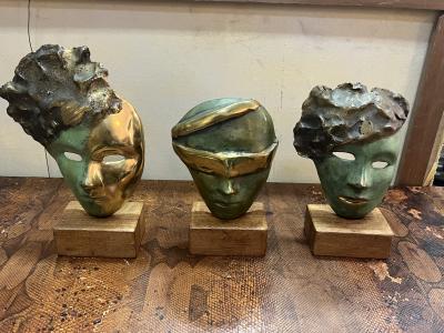 MODERNIST SUITE OF THREE BRUTALIST BRONZE MASK SCULPTURES