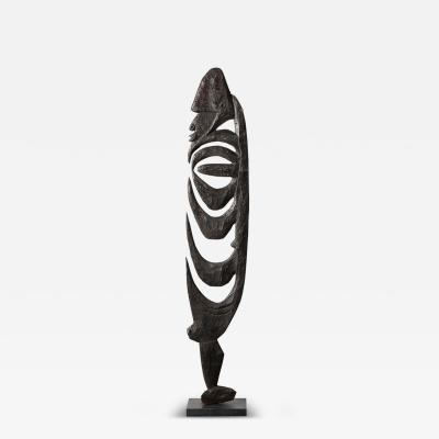 Male Yipwon Figural Carved Wood Sculpture on Stone Base