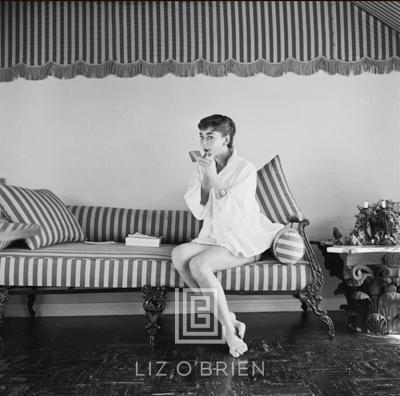 Mark Shaw Audrey Hepburn on Striped Sofa Applies Lipstick 1954