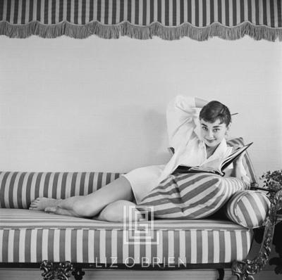Mark Shaw Audrey Hepburn on Striped Sofa Arm Back Smiling 1954