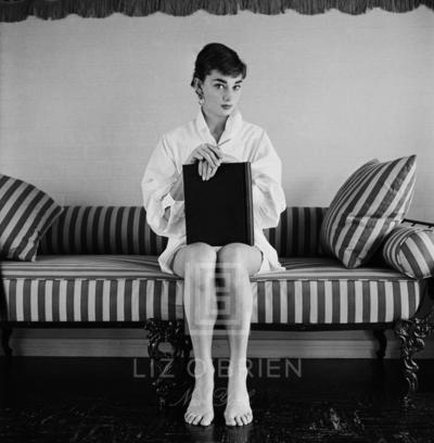 Mark Shaw Audrey Hepburn on Striped Sofa Hands on Closed Book 1954