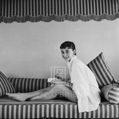 Mark Shaw Audrey Hepburn on Striped Sofa Leans Forward Smiling 1954