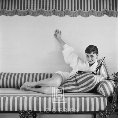 Mark Shaw Audrey Hepburn on Striped Sofa Reclines Hand Up Book Open 1954