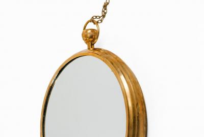 Mid Century Modern brass mirror in the manner of Fornasetti
