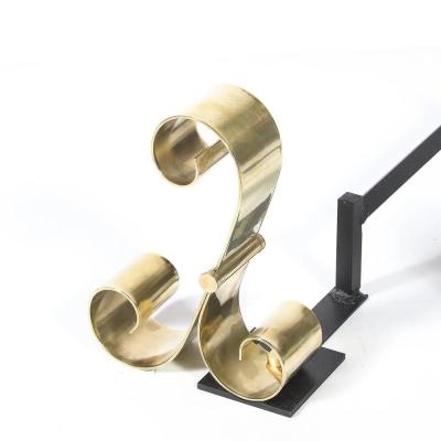 Mid Century Modernist Scroll Form Andirons in Polished Brass