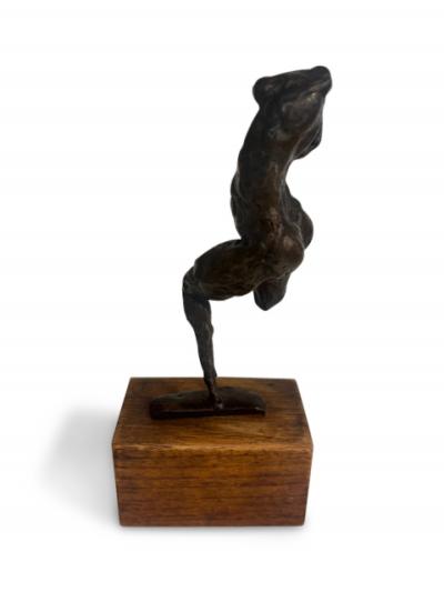Mid Century small bronze contorting female nude on a wood base
