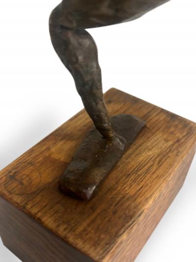 Mid Century small bronze contorting female nude on a wood base