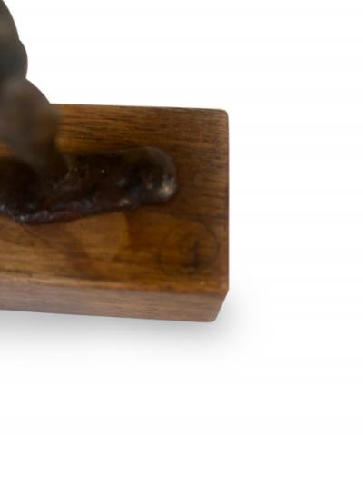 Mid Century small bronze contorting female nude on a wood base