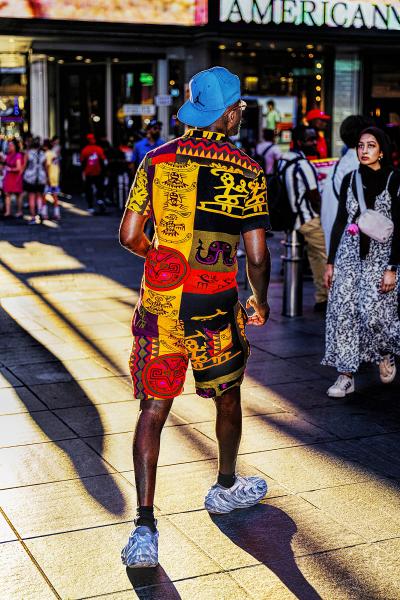 Mitchell Funk Man in Colorful African Theme Clothes Illuminated by Shaft of Light