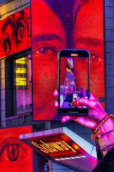 Mitchell Funk Times Square Cell Phone in Neon Reds Street Photography