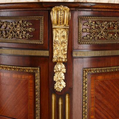 Neoclassical style marble and ormolu mounted wood commode after Leleu