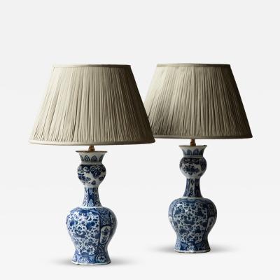 OCTAGONAL DUTCH DELFT BLUE AND WHITE WAISTED BOTTLE VASES CONVERTED TO LAMPS