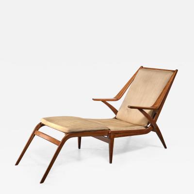 Oak lounge chair with fold out footstool