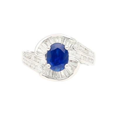 Oval Cut Blue Sapphire with Round Baguette Cut Diamonds in a Swirled