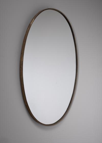 Oval brass mirror with beaded decoration