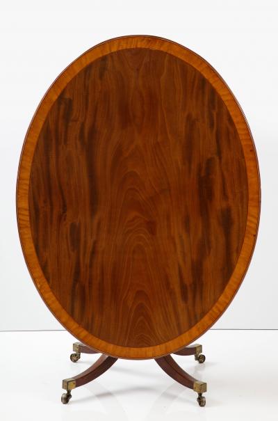 Oval mahogany breakfast table banded in satinwood 