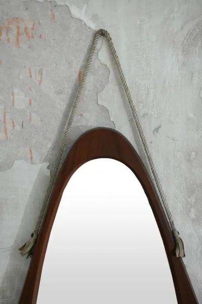Oval mirror with wooden frame and leather cord details 1950s