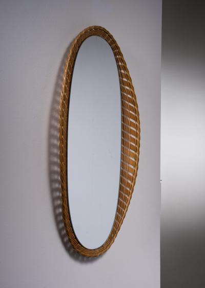 Oval wall mirror with a wooden and rattan frame