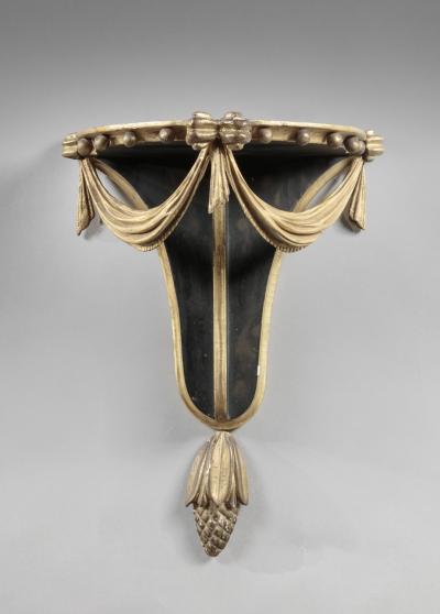 PAIR OF CARVED EBONIZED AND GILDED BRACKETS