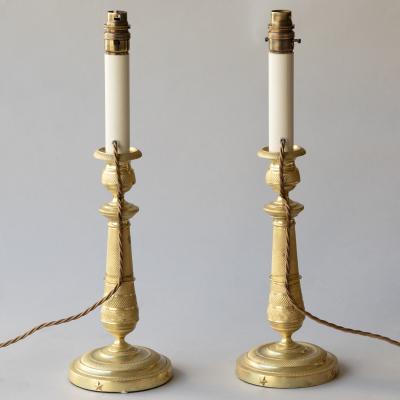 PAIR OF EARLY 19TH CENTURY GILT BRONZE CANDLESTICKS CONVERTED TO TABLE LAMPS