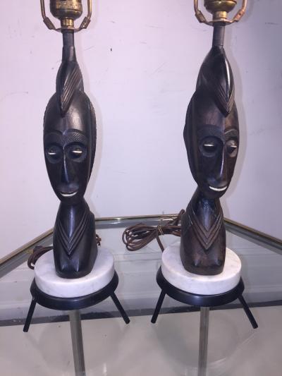 PAIR OF MID CENTURY CARVED WOOD AFRICAN BUST ON TRIPOD MARBLE BASE LAMPS