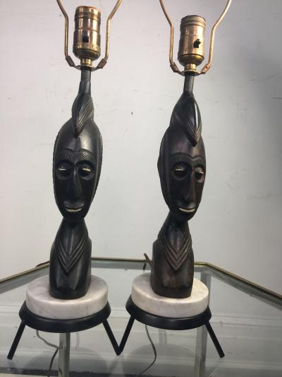 PAIR OF MID CENTURY CARVED WOOD AFRICAN BUST ON TRIPOD MARBLE BASE LAMPS