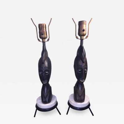 PAIR OF MID CENTURY CARVED WOOD AFRICAN BUST ON TRIPOD MARBLE BASE LAMPS