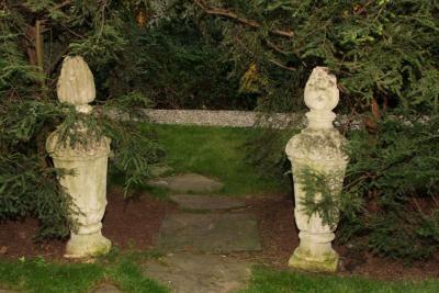 PAIR OF TALL CARVED STONE FLAME FINIALS