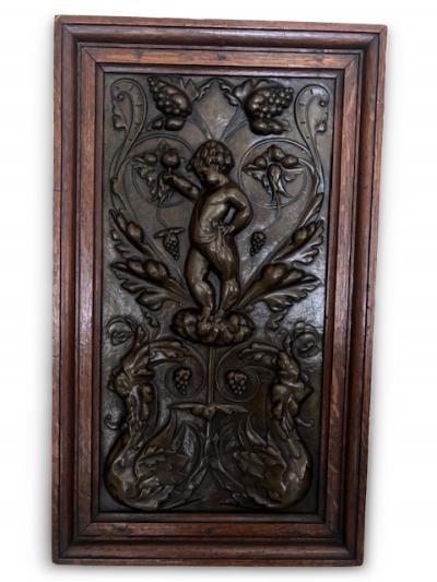 PAIR of French Victorian oak framed brass embossed cupid wall plaques