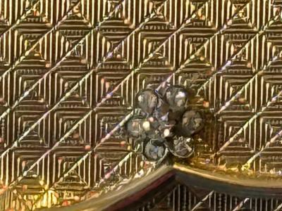 POLISHED GOLDTONE METAL CLUTCH WITH RHINESTONE FLORET ACCENTS