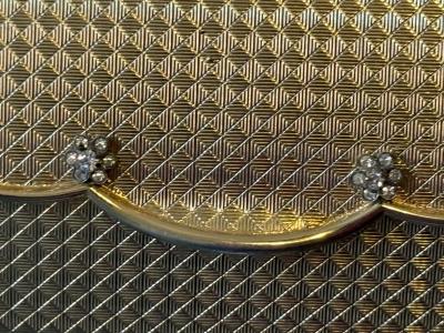 POLISHED GOLDTONE METAL CLUTCH WITH RHINESTONE FLORET ACCENTS