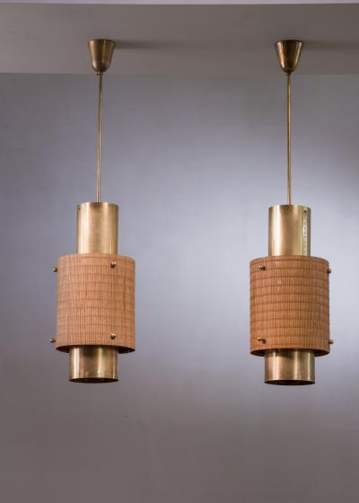 Paavo Tynell Pair of Paavo Tynell brass and wood pendant lamps