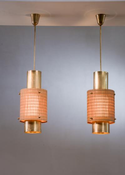 Paavo Tynell Pair of Paavo Tynell brass and wood pendant lamps